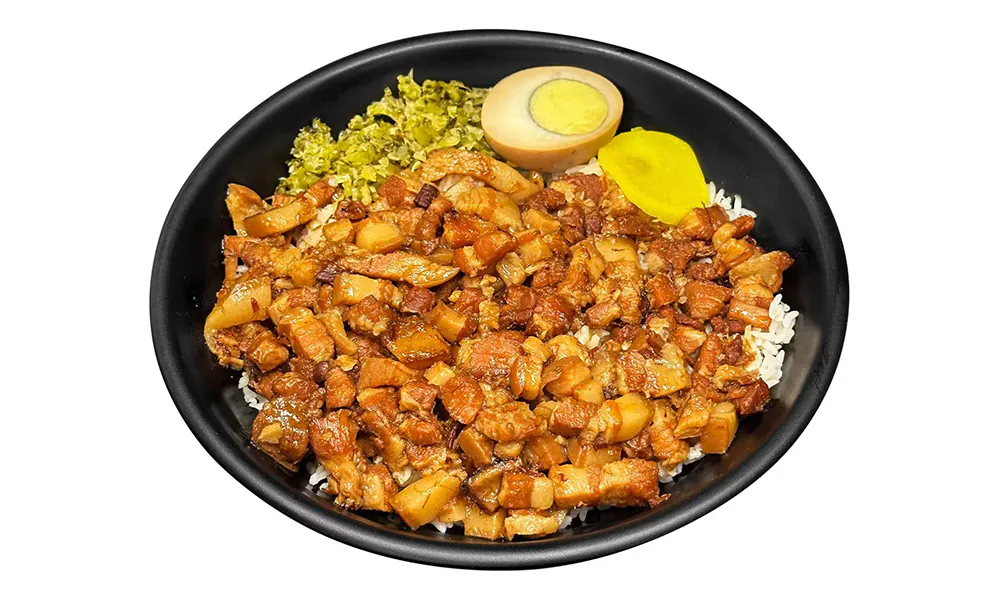 Savory braised pork over rice, accompanied by pickled egg and veggies at Chef Ge, a Chinese Restaurant in Highland Park