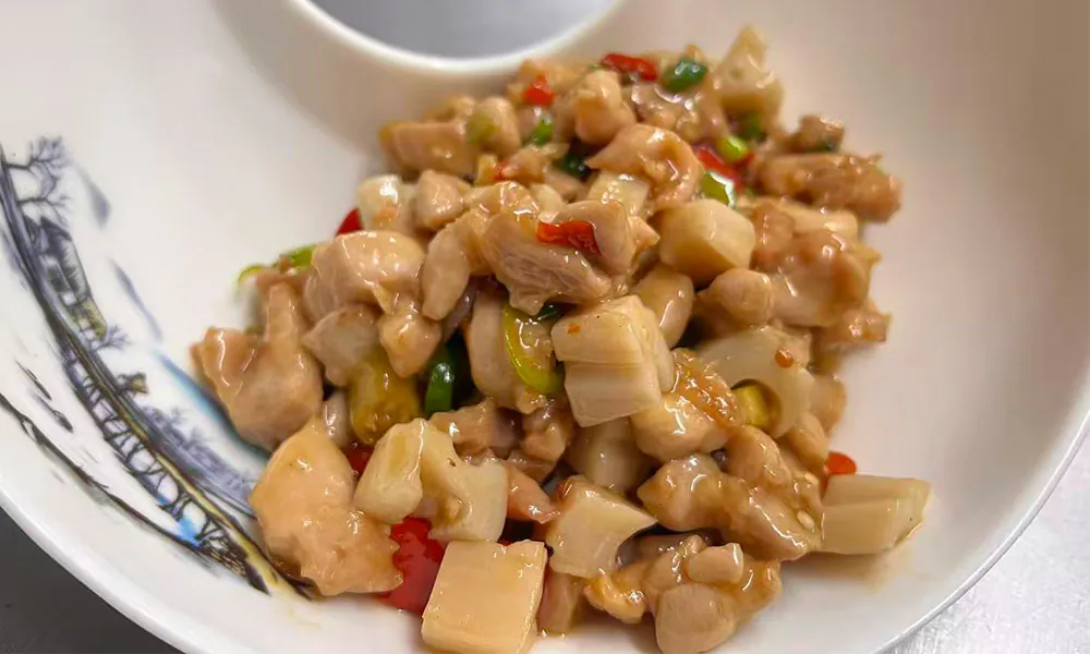 Tender chicken and crisp lotus root stir-fried with peppers, flavorful and spicy at Chef Ge, a Chinese Restaurant in Highland Park