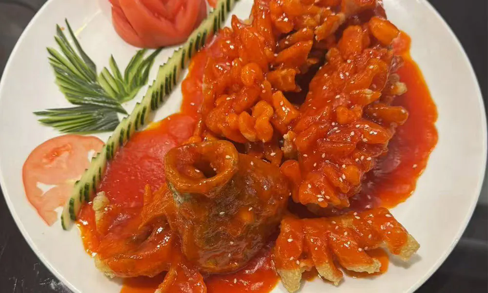Crispy fish in sweet and sour tomato sauce, artistically plated at Chef Ge, a Chinese Restaurant in Highland Park